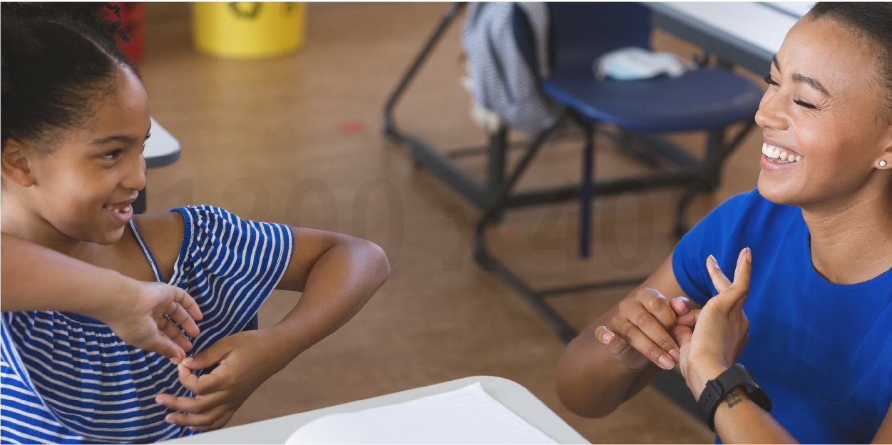 Teacher and student communicating with sign language