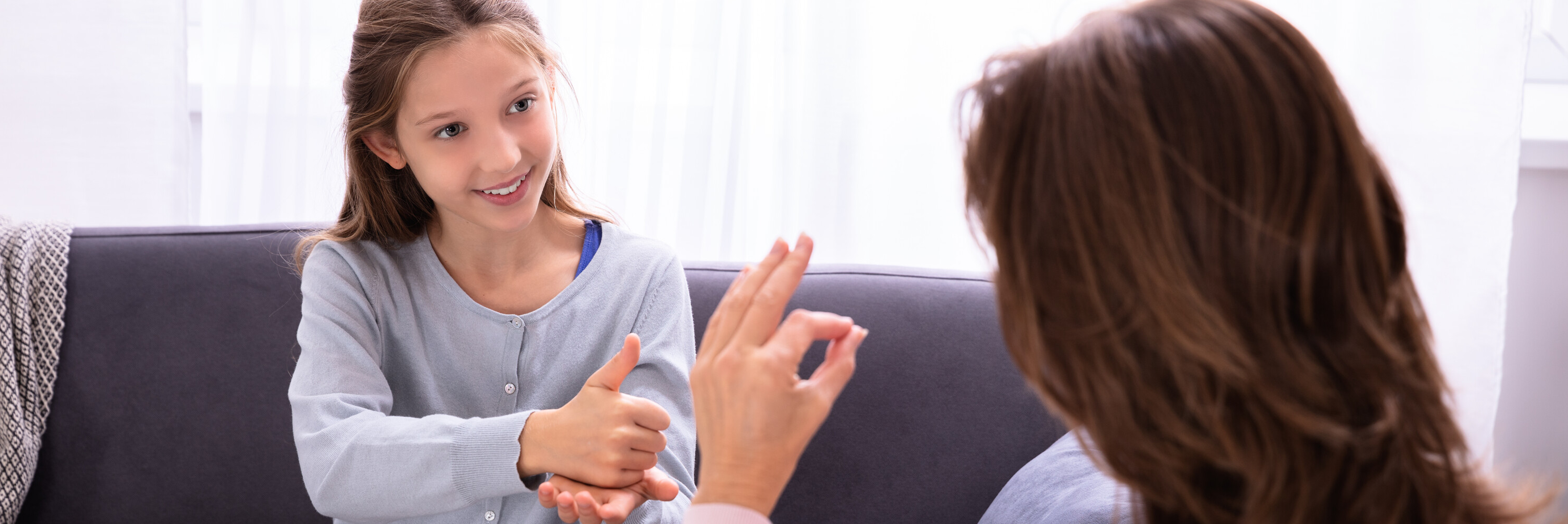 Photo of a student and teacher using American Sign Language