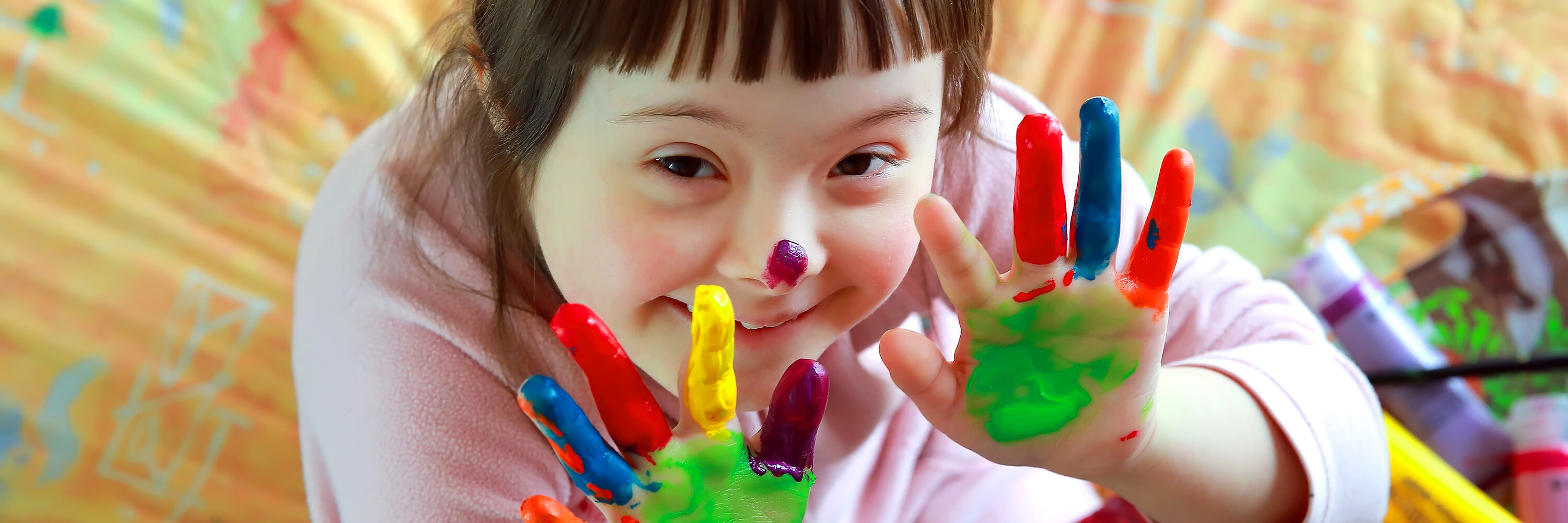 Photo of a girl with paint in her hands during art class