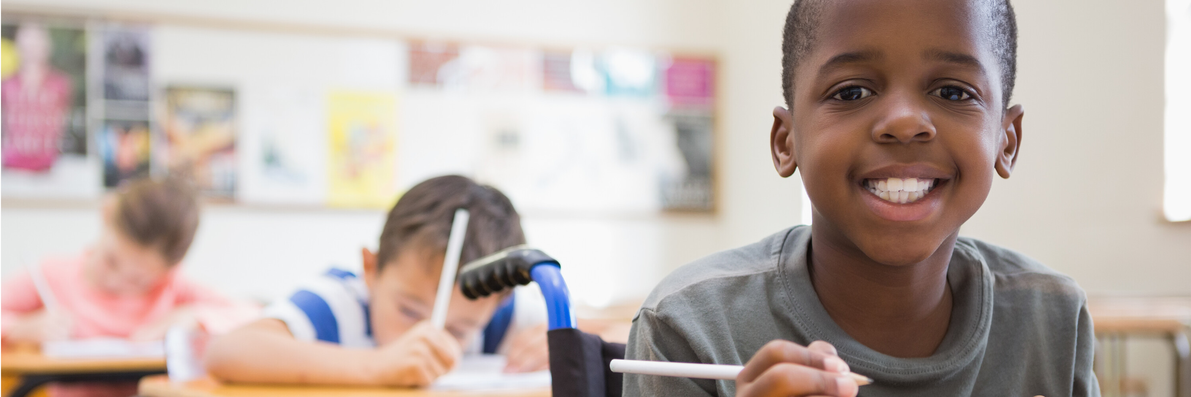 diverse group of students writing in the classroom